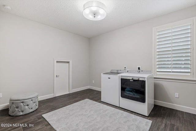 washroom with a textured ceiling, independent washer and dryer, and dark hardwood / wood-style floors