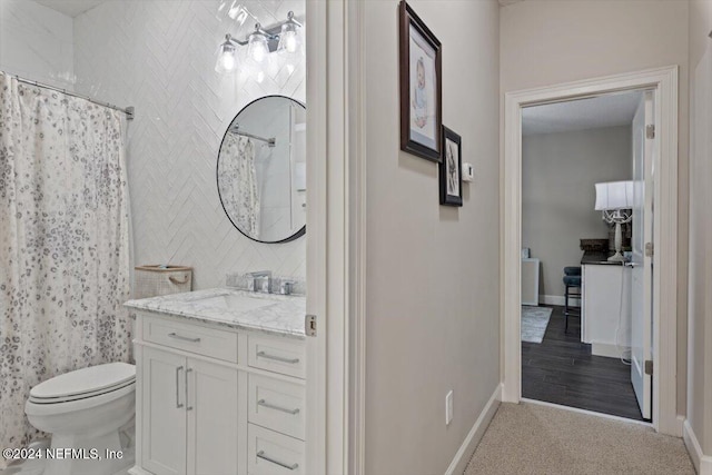 bathroom featuring vanity, toilet, hardwood / wood-style flooring, and a shower with curtain