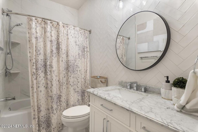 full bathroom with tile walls, vanity, shower / bath combo, and toilet