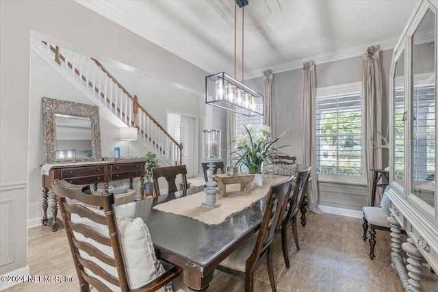 dining space featuring crown molding