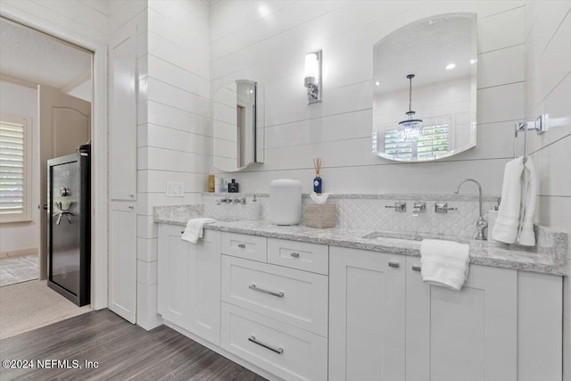 bathroom featuring vanity, hardwood / wood-style floors, and a textured ceiling