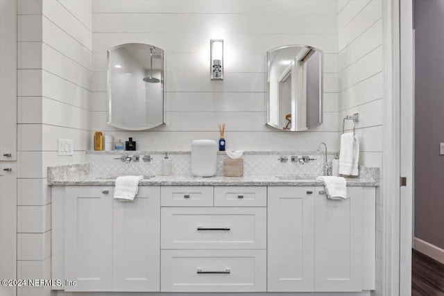 bathroom with vanity, backsplash, and wood-type flooring