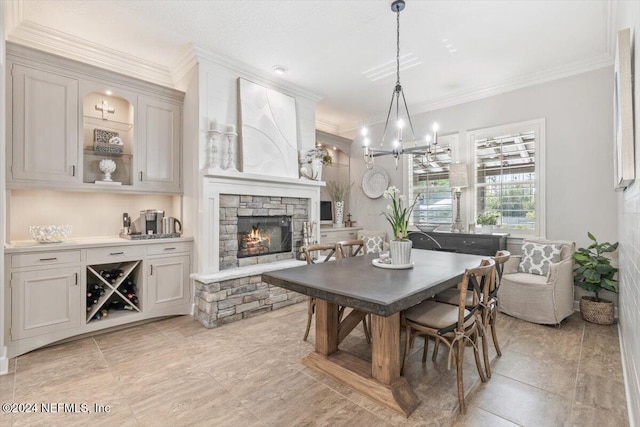 dining space featuring an inviting chandelier, ornamental molding, and a fireplace