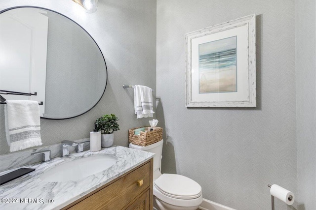 bathroom with toilet and vanity