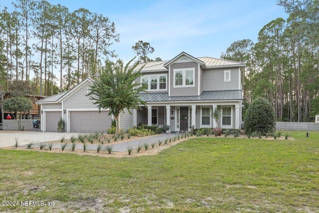 10225 Russell Sampson Rd, Saint Johns, FL 32259 - view of front facade with a standing seam roof, covered porch, driveway, a garage, and metal roof