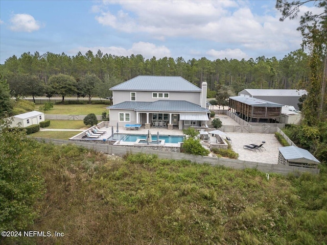 rear view of house featuring a patio and a yard