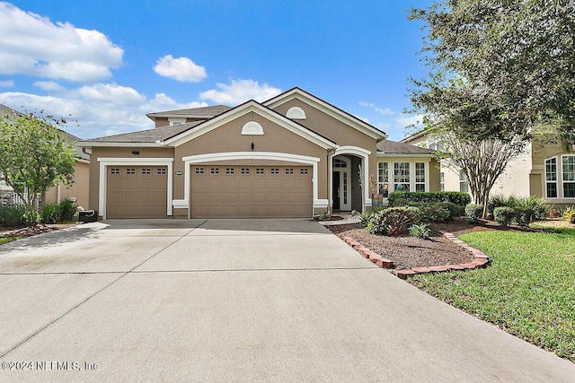 view of front facade with a front yard and a garage