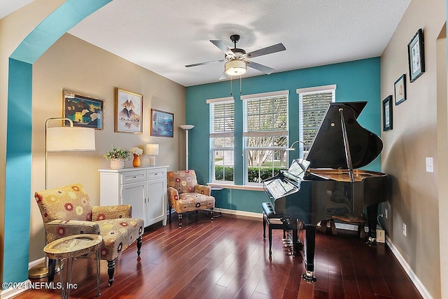 sitting room featuring ceiling fan, a textured ceiling, and dark hardwood / wood-style floors