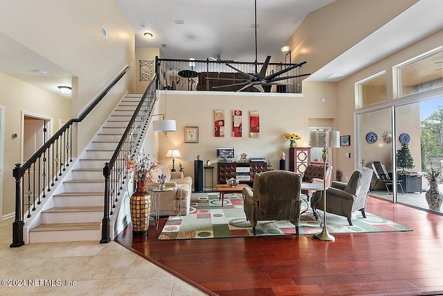 dining space featuring light hardwood / wood-style floors and a towering ceiling