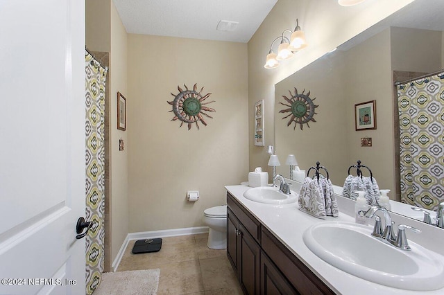 bathroom featuring vanity, toilet, a textured ceiling, and tile patterned flooring