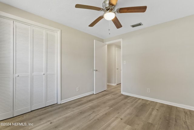 unfurnished bedroom featuring a closet, ceiling fan, and light wood-type flooring