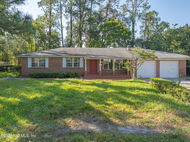 single story home featuring a front yard and a garage