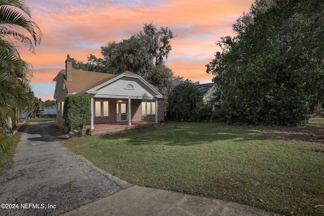 view of front facade featuring a porch and a lawn