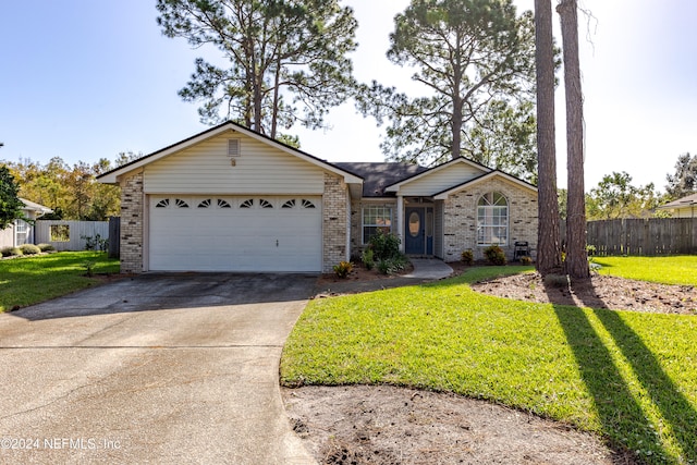 ranch-style home with a garage and a front yard