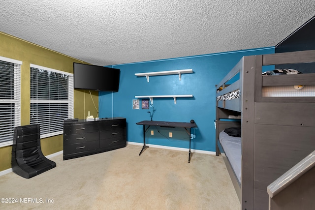 bedroom with a textured ceiling and carpet floors