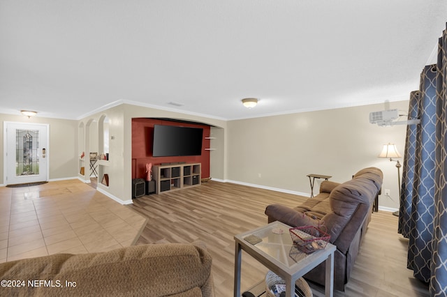 living room featuring hardwood / wood-style flooring and crown molding