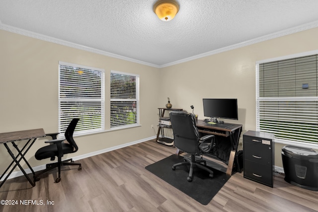 office space featuring a textured ceiling, light wood-type flooring, and ornamental molding