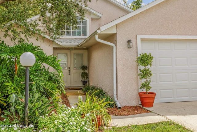 doorway to property featuring a garage