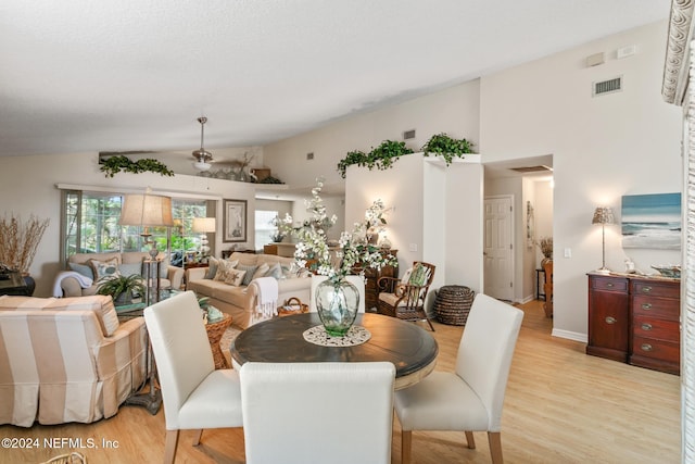 dining space with vaulted ceiling, light wood-type flooring, and ceiling fan