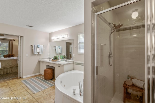 bathroom featuring vanity, tile patterned flooring, plus walk in shower, and a wealth of natural light