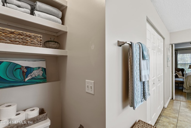 bathroom with hardwood / wood-style floors and a textured ceiling