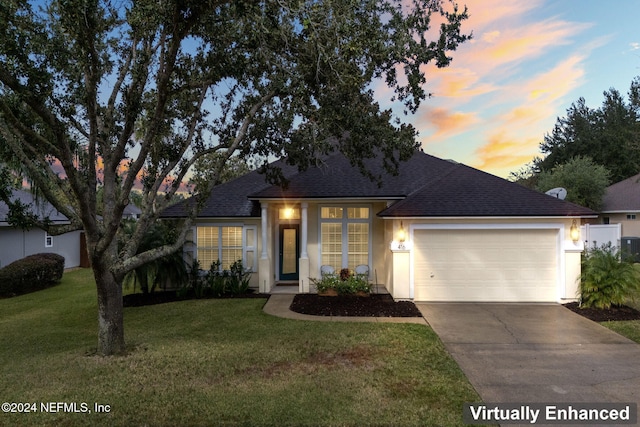 single story home with a yard and a garage