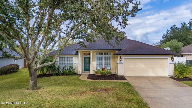 ranch-style home with a front yard and a garage