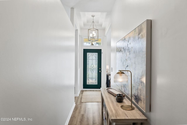 doorway featuring hardwood / wood-style floors and an inviting chandelier