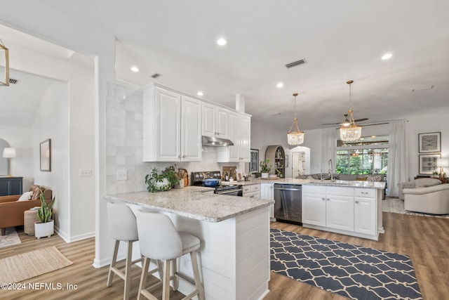 kitchen with pendant lighting, white cabinets, kitchen peninsula, and stainless steel appliances