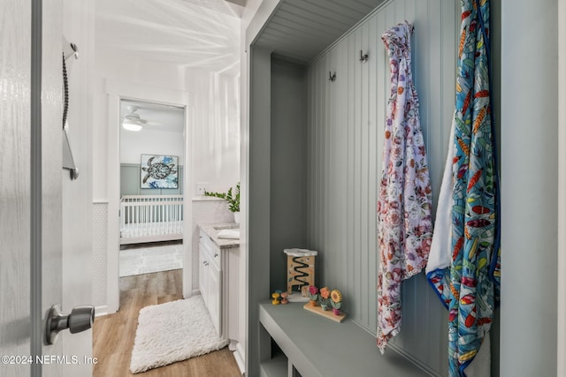 bathroom with vanity, ceiling fan, and wood-type flooring