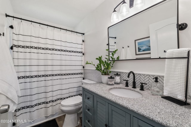 bathroom featuring vanity, toilet, backsplash, and a shower with shower curtain