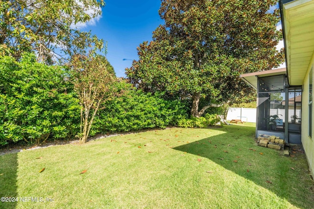 view of yard featuring a sunroom