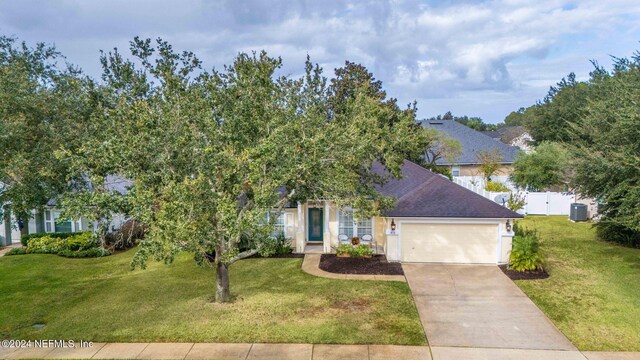 obstructed view of property featuring a front lawn and a garage