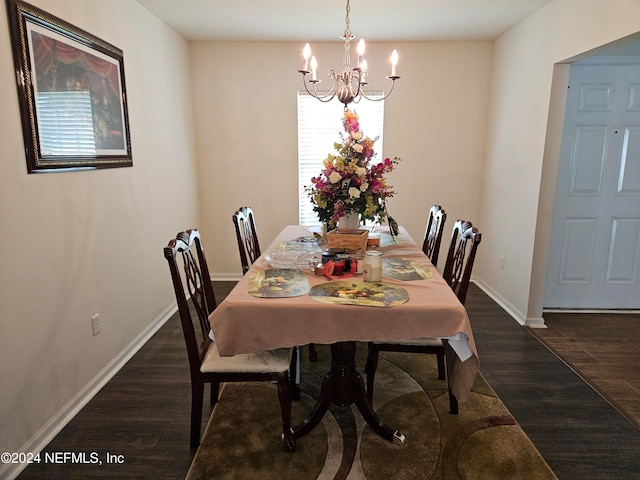 dining room featuring an inviting chandelier and dark hardwood / wood-style flooring