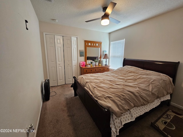 carpeted bedroom featuring a closet, ceiling fan, and a textured ceiling