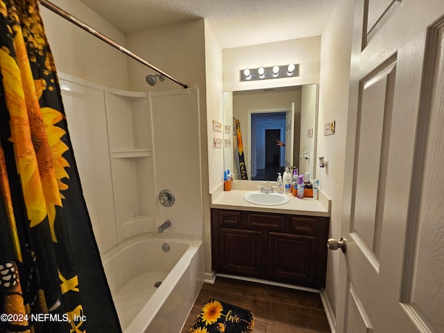 bathroom featuring vanity, a textured ceiling, shower / bath combination with curtain, and wood-type flooring