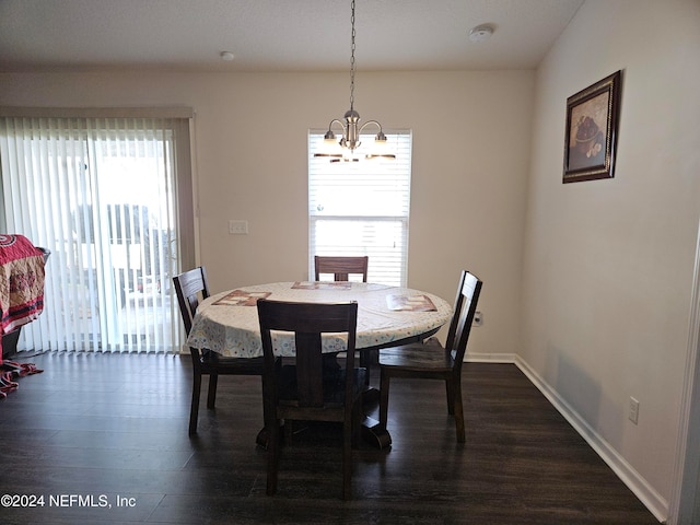 dining room featuring an inviting chandelier and dark hardwood / wood-style flooring