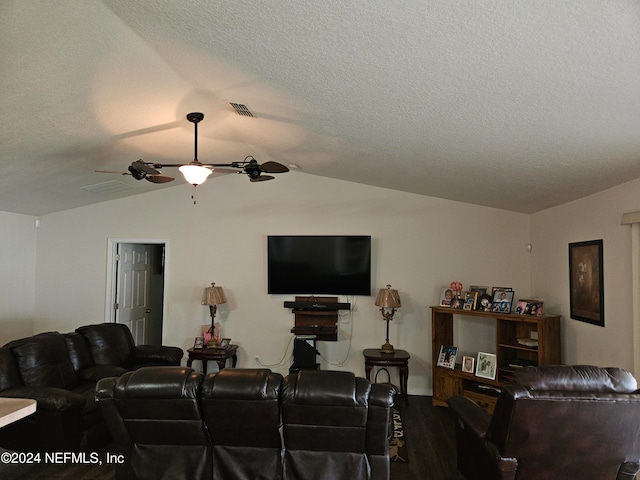 living room featuring ceiling fan, a textured ceiling, wood-type flooring, and lofted ceiling