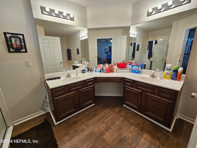 bathroom featuring vanity, wood-type flooring, and a shower with door