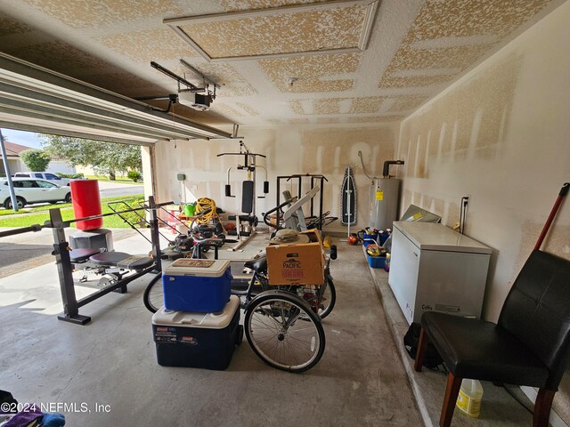 garage with a garage door opener, electric water heater, and refrigerator