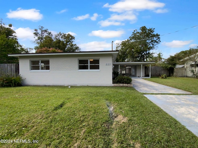 single story home with a front lawn and a carport