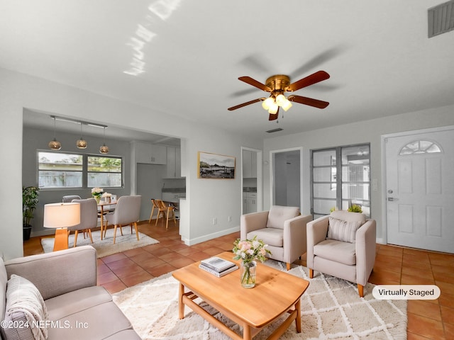 tiled living room featuring ceiling fan