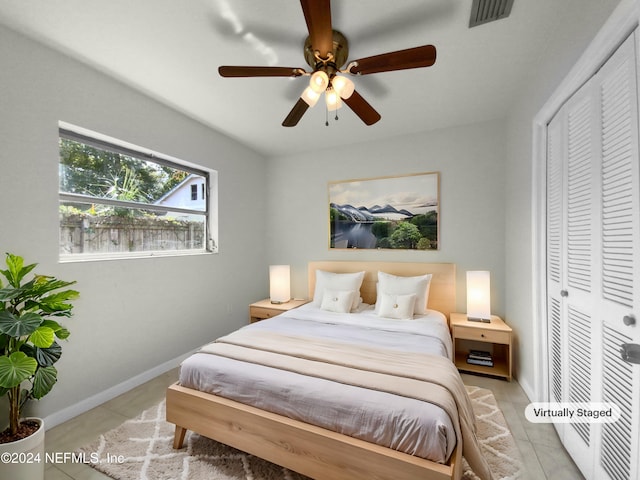 bedroom featuring a closet, ceiling fan, and light tile patterned flooring