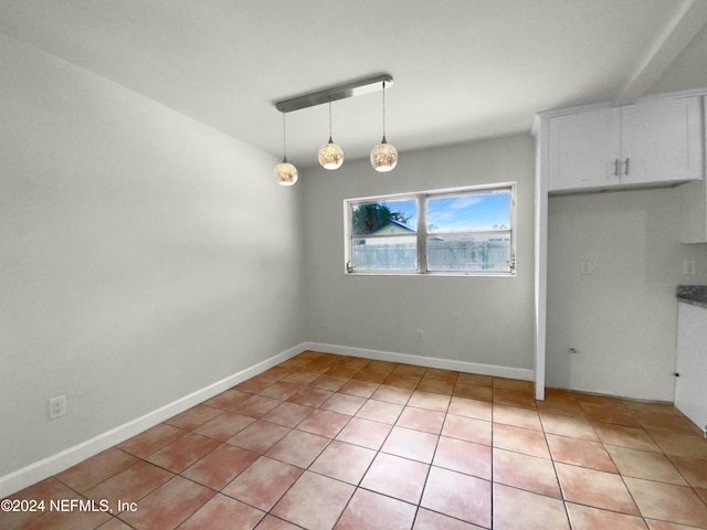 unfurnished dining area with light tile patterned flooring