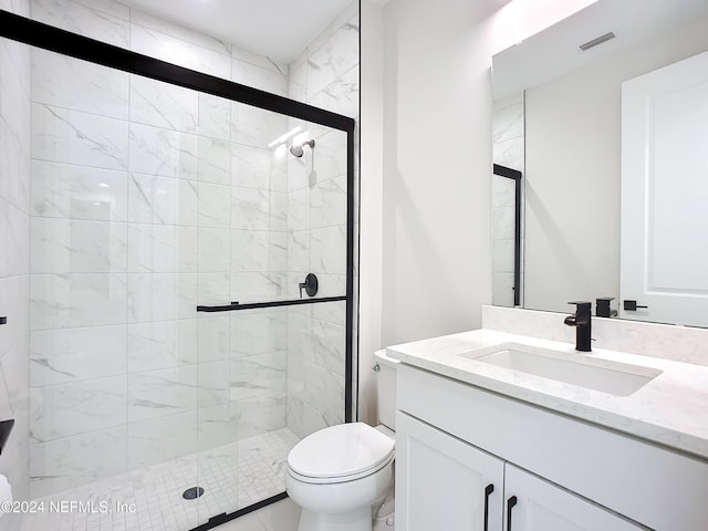 bathroom with vanity, toilet, and an enclosed shower