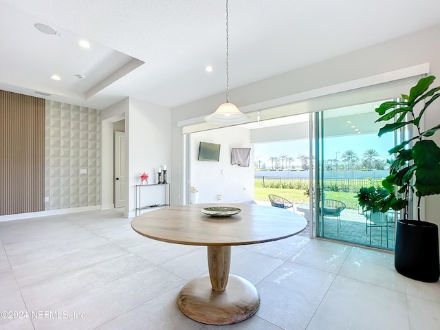 unfurnished dining area featuring light tile patterned flooring