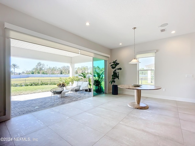 interior space with tile patterned floors and a healthy amount of sunlight