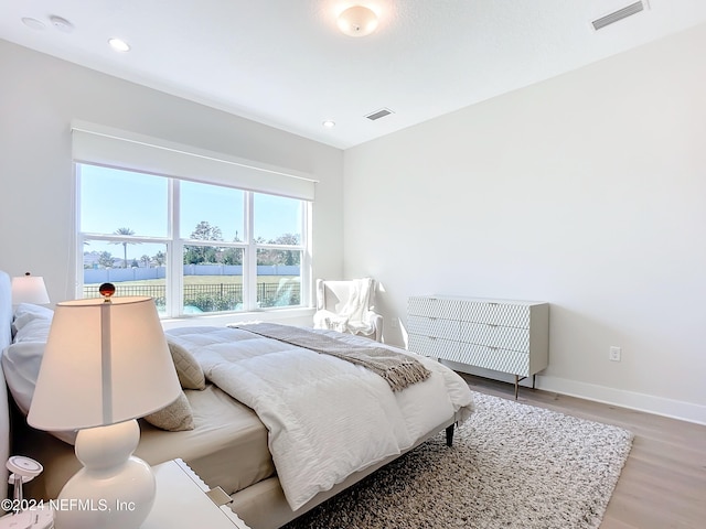 bedroom with hardwood / wood-style flooring