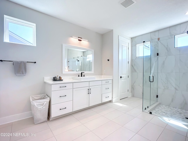 bathroom with tile patterned flooring, vanity, and a shower with door