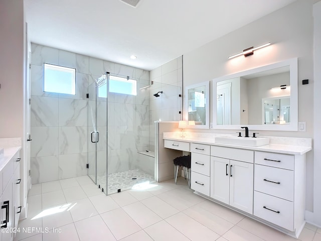 bathroom with tile patterned floors, a shower with door, and vanity